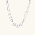 Sterling silver multi-strand necklace with three brushed round beads on cream background