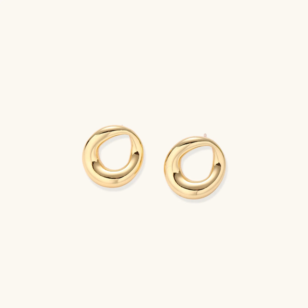 Pair of polished 18K gold-plated stainless steel teardrop earrings with hollow centers on cream background